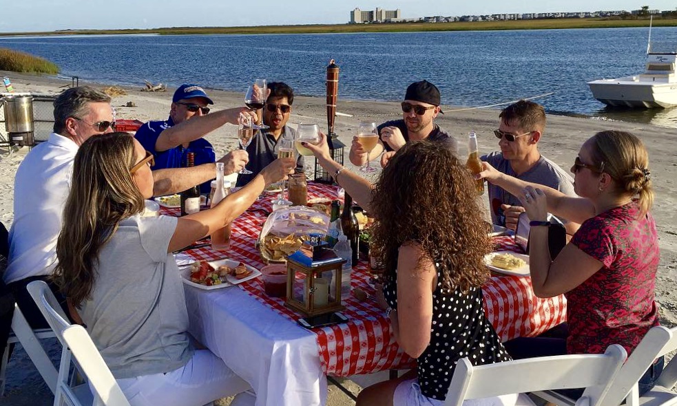 a group of people sitting at a picnic table