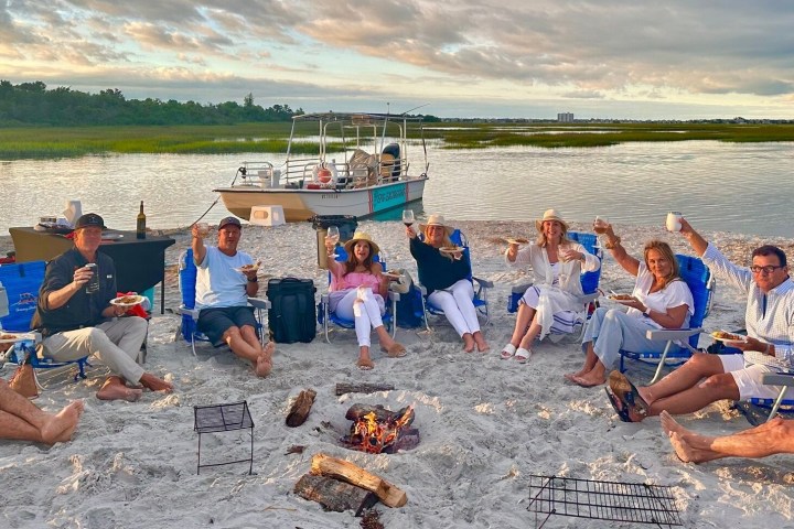 a group of people sitting at a beach